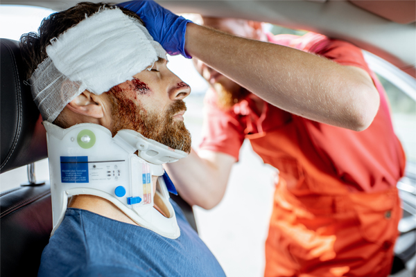 a man is put in a neck brace after he is injured in a car accident.