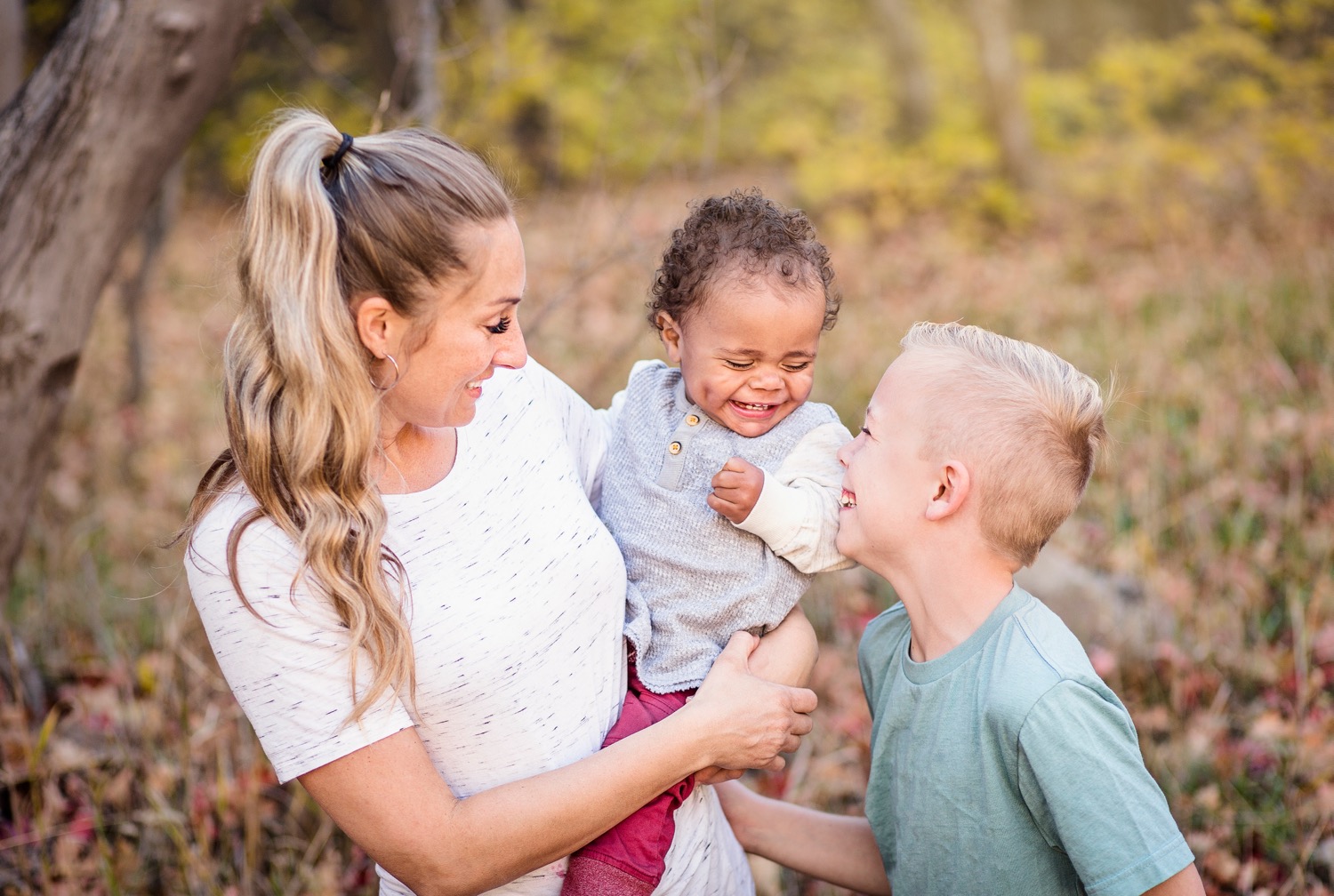 A young mother enjoying time with the children she adopted after learning about Virginia adoption laws.
