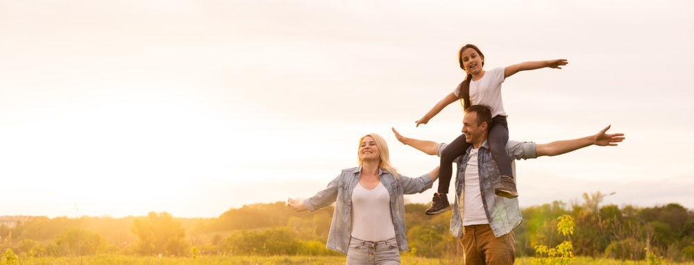 a young family takes in fresh air in an open field