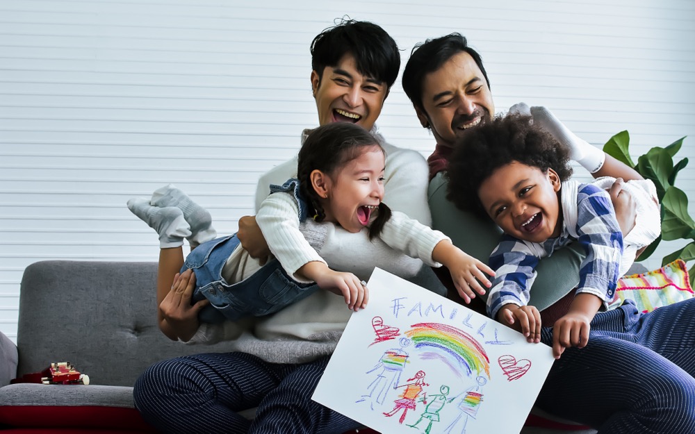 a same-sex couple are the adoptive parents of two young children